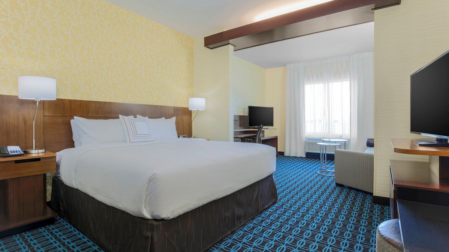 King Suite with a large king bed with loung area and work station