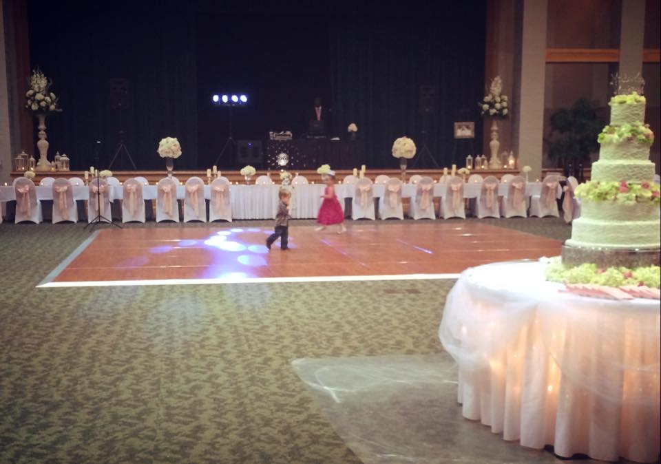 Pastel themed wedding reception view of the head and cake tables